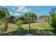 Back of house showing sunroom and patio at 1702 Blind Pond Ave, Lutz, FL 33549