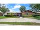 Brick house with a circular driveway and palm trees at 1702 Blind Pond Ave, Lutz, FL 33549