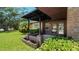Covered entryway with brick planters and lush greenery at 1702 Blind Pond Ave, Lutz, FL 33549