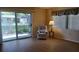 Bright living room featuring sliding glass doors and laminate flooring at 6263 Green View Cir # 107, Sarasota, FL 34231