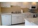 Efficient kitchen with white cabinets and appliances at 6263 Green View Cir # 107, Sarasota, FL 34231
