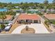 An inviting property boasts a terracotta roof, extended driveway, and landscaping, all within a well-maintained neighborhood at 186 45Th Ave, St Pete Beach, FL 33706