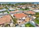 Aerial shot of a backyard featuring a patio area, a white fence, and tropical foliage at 186 45Th Ave, St Pete Beach, FL 33706