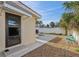 Cozy backyard featuring a concrete patio, gravel landscaping, a small pergola and mature palm trees at 186 45Th Ave, St Pete Beach, FL 33706