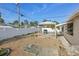 Fenced backyard featuring gravel landscaping and a covered patio with a grill at 186 45Th Ave, St Pete Beach, FL 33706