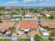 Aerial view of the backyard featuring a patio area, a white fence, and tropical foliage at 186 45Th Ave, St Pete Beach, FL 33706