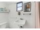 Simple bathroom featuring a sink, window, mirror and minimal decor at 186 45Th Ave, St Pete Beach, FL 33706