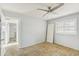 Bedroom featuring a ceiling fan, a window with blinds, and a doorway leading to an adjacent space at 186 45Th Ave, St Pete Beach, FL 33706