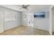 Bright bedroom with a ceiling fan, window with blinds and a doorway leading to another room at 186 45Th Ave, St Pete Beach, FL 33706