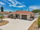Inviting single-story home features a red tile roof, neutral stucco, and long driveway with unique front yard design at 186 45Th Ave, St Pete Beach, FL 33706