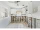 Bright kitchen with white cabinets, tile flooring and open to the studs, ready for remodel at 186 45Th Ave, St Pete Beach, FL 33706