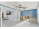 Cozy living room with tile flooring, ceiling fan, and glass doors to adjacent room at 186 45Th Ave, St Pete Beach, FL 33706