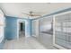 Bright living room with tile floors, ceiling fan, and glass doors to adjacent room at 186 45Th Ave, St Pete Beach, FL 33706