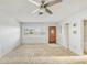 Bright living room with ceiling fan, plantation shutters, hardwood door, and flooring ready for updating at 186 45Th Ave, St Pete Beach, FL 33706