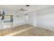 Open living room area, ceiling fan, adjacent view of kitchen and tile flooring at 186 45Th Ave, St Pete Beach, FL 33706