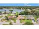 Beautiful aerial view of the home with access to a lake, lush landscaping, and a large private backyard at 2115 Seagull Dr, Clearwater, FL 33764