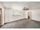Neutral bedroom featuring a ceiling fan, carpet flooring, baseboard trim, a sliding door and window view at 2115 Seagull Dr, Clearwater, FL 33764