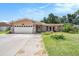 Charming home with a two-car garage, stone accents, and manicured lawn enhancing curb appeal in a lovely neighborhood at 2115 Seagull Dr, Clearwater, FL 33764