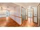 Bright hallway with hardwood floors, elegant lighting, and multiple doorways that enhance the home's open layout at 2115 Seagull Dr, Clearwater, FL 33764