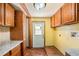 Mud room featuring tile flooring, cabinets, countertops, and a door to the exterior at 2115 Seagull Dr, Clearwater, FL 33764