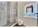 Modern bathroom featuring a glass shower, marble, and stylish vanity with light at 6540 Simone Shores Cir, Apollo Beach, FL 33572
