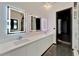 Modern bathroom boasts a long vanity with dual sinks and illuminated mirrors at 6540 Simone Shores Cir, Apollo Beach, FL 33572
