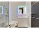 Modern bathroom featuring a glass shower, marble, and stylish vanity with light at 6540 Simone Shores Cir, Apollo Beach, FL 33572