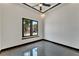 Bright bedroom with modern ceiling fan, sleek tile floors, and a large window at 6540 Simone Shores Cir, Apollo Beach, FL 33572