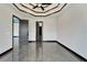 Bedroom featuring an open doorway and tray ceiling with gray marble floors at 6540 Simone Shores Cir, Apollo Beach, FL 33572