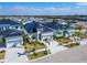 This new construction features a modern design with palm trees, a black roof, and a paver driveway at 6540 Simone Shores Cir, Apollo Beach, FL 33572