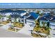Modern new construction home with black roof, paver driveway, and tidy landscaping at 6540 Simone Shores Cir, Apollo Beach, FL 33572