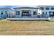 Backyard view of a modern home featuring a pristine lawn, and secure black fencing at 6540 Simone Shores Cir, Apollo Beach, FL 33572