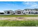View of modern homes with sleek design, complemented by well-maintained lawns at 6540 Simone Shores Cir, Apollo Beach, FL 33572