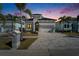Charming two-story home featuring a paved driveway, minimalist landscaping, and a two-car garage at 6540 Simone Shores Cir, Apollo Beach, FL 33572