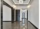 Modern foyer with a chandelier, gray marble flooring, and dark trim at 6540 Simone Shores Cir, Apollo Beach, FL 33572