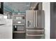 Modern kitchen featuring black stainless appliances, microwave oven and refrigerator at 6540 Simone Shores Cir, Apollo Beach, FL 33572