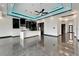 Spacious modern kitchen features a center island, glossy cabinets, and gorgeous custom lighting at 6540 Simone Shores Cir, Apollo Beach, FL 33572