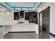 Modern kitchen with an island, black stainless appliances and a sliding barn door at 6540 Simone Shores Cir, Apollo Beach, FL 33572