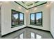 Modern living room with large windows and a decorative chandelier at 6540 Simone Shores Cir, Apollo Beach, FL 33572