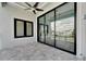 Spacious outdoor patio with fan and large sliding glass doors, perfect for entertaining and relaxation at 6540 Simone Shores Cir, Apollo Beach, FL 33572
