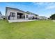 Rear view of a modern house with a large backyard at 6540 Simone Shores Cir, Apollo Beach, FL 33572