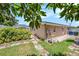 Landscaped backyard with stone pathway and shed at 2115 Seagull Dr, Clearwater, FL 33764
