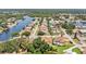 Wide aerial view showing neighborhood, waterways, and home at 2115 Seagull Dr, Clearwater, FL 33764