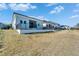 The vast backyard extends from the rear of the house, complemented by modern fences and a well-kept lawn at 6542 Simone Shores Cir, Apollo Beach, FL 33572