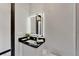 Modern bathroom featuring a black countertop and illuminated mirror above vanity at 6542 Simone Shores Cir, Apollo Beach, FL 33572