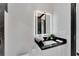 Modern bathroom vanity featuring a black countertop and illuminated mirror at 6542 Simone Shores Cir, Apollo Beach, FL 33572