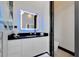 Modern bathroom featuring a black countertop and illuminated mirror with blue ambient lighting at 6542 Simone Shores Cir, Apollo Beach, FL 33572