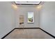 Minimalist bedroom with neutral tones, a view to the outside, and modern architectural detailing at 6542 Simone Shores Cir, Apollo Beach, FL 33572