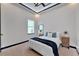 Cozy bedroom with a queen bed, modern nightstands, and a large window at 6542 Simone Shores Cir, Apollo Beach, FL 33572