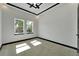 Bright bedroom with neutral carpet and black trim around two windows at 6542 Simone Shores Cir, Apollo Beach, FL 33572